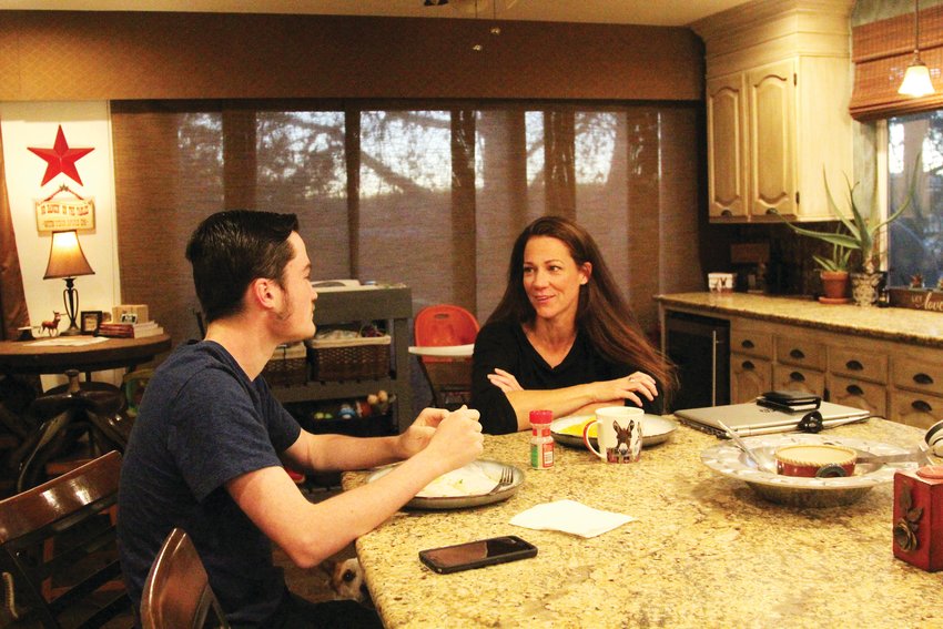 Ben Wann speaks with his mother, Amber, over breakfast on Nov. 18.