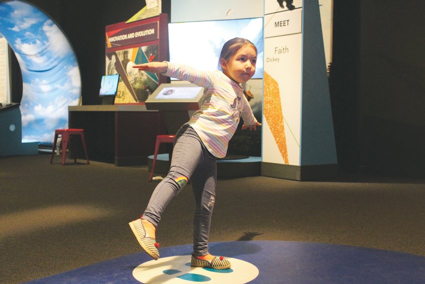 Mia Rios tests her kinesthetic sense at the exhibit. The temporary exhibit comes from Science North, a museum in Ontario, Canada. It’s on display until April 12 of next year at the Denver Museum of Nature &amp; Science.