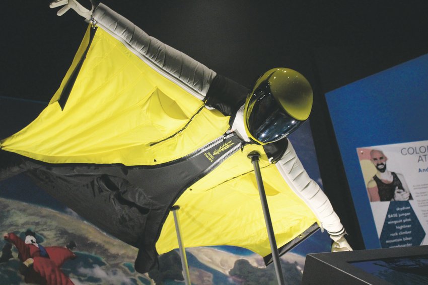 Above, a wingsuit. The exhibit features information on Colorado athletes, including Andrew Fraser. He uses the wingsuit to achieve his childhood goal of flying and says it takes athleticism, strength, balance, and mental fortitude to be able to use it.
