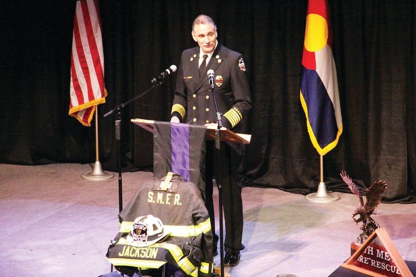 South Metro Fire Rescue Chief Bob Baker speaks Dec. 20 at the memorial service for former Assistant Chief Troy Jackson. At the foot of the stage, Jackson’s uniform lay.