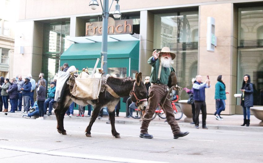 A miner and his burro represent Colorado’s mining history at the Stock Show Kick-off Parade in downtown Denver on Jan. 9.