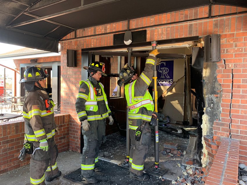 South Metro firefighters examine the scene Feb. 17 after a vehicle crashed into the Boardroom restaurant in Littleton.