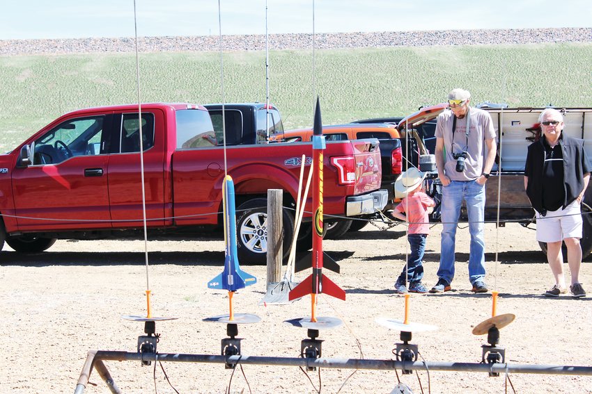 Pictured, a row of launchpads set up at a CRASH event. There are over 80,000 sport rocket modelers in the National Association of Rocketry.