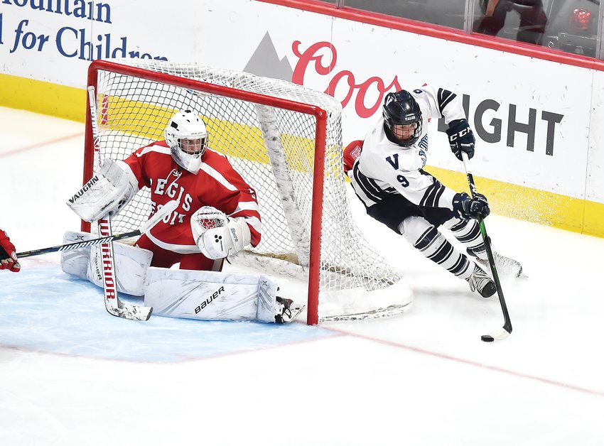 Valor Christian's Evan Pahos (9) emerges from the backside of the goal as Regis Jesuit's Gage Bussey closes off access down low. The Eagles ended up on top 2-1 in Frozen Four action March 5 at the Pepsi Center and advanced to the finals.