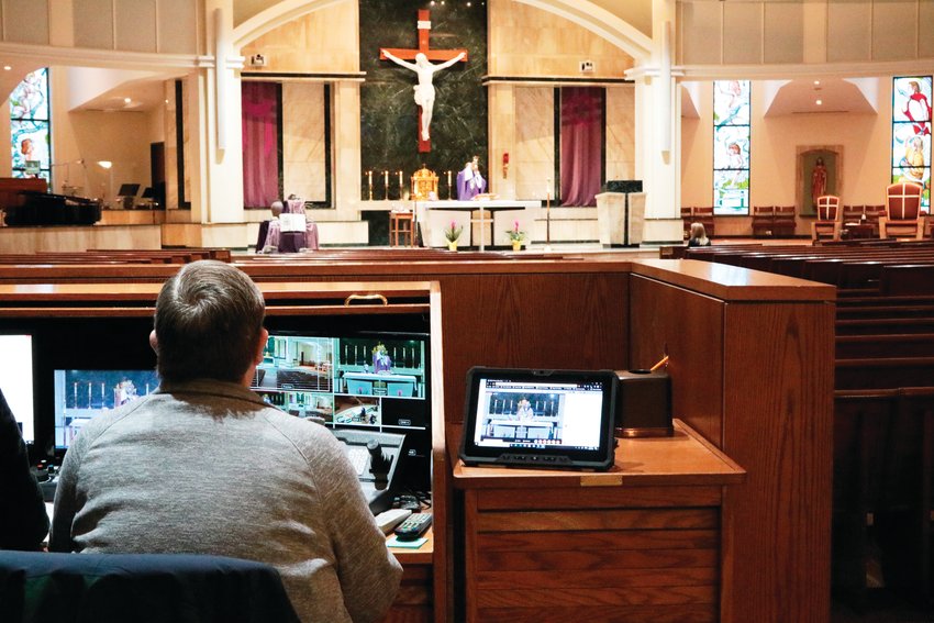 The audiovisual team at St. Thomas More Catholic Church worked to maintain a livestream of the church's daily mass, Friday March 20.