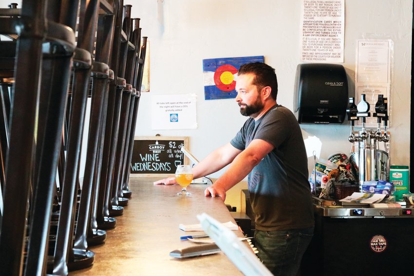 Dave Gardner, owner of Max Taps in Highlands Ranch, stands behind the bar of the taphouse a few days after it was closed down by the governor in an attempt to contain COVID-19.