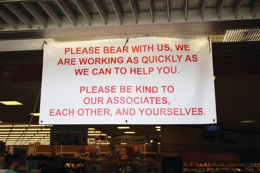 A sign that hangs outside the front of the King Soopers at 6350 Sheridan Blvd. Grocery stores have seen an increase in customers since the COVID-19 pandemic began. Many grocery stores have changed their hours to clean and restock shelves.