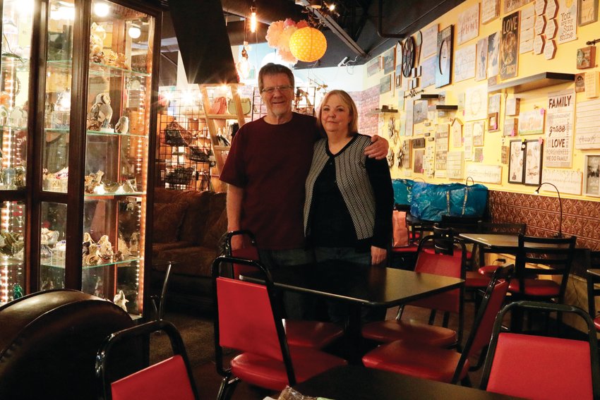 Tony and Dawn Whitham stand inside their store, Festive Cup Coffee, a few days after they were required to shut down all dine-in service there. While a few customers trickled in throughout the day to pick up items, the store was mostly empty.