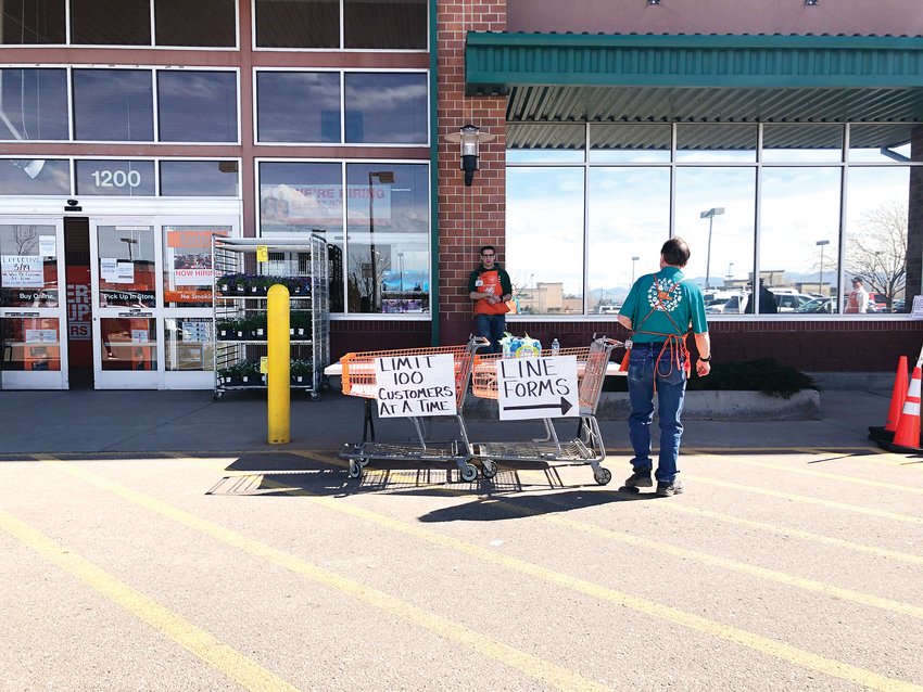 Home Depot employees manage the line outside of the store in Highlands Ranch in late March. Employees said people were mostly buying home improvement gear, cleaning products and supplies for home repairs in case of an emergency.