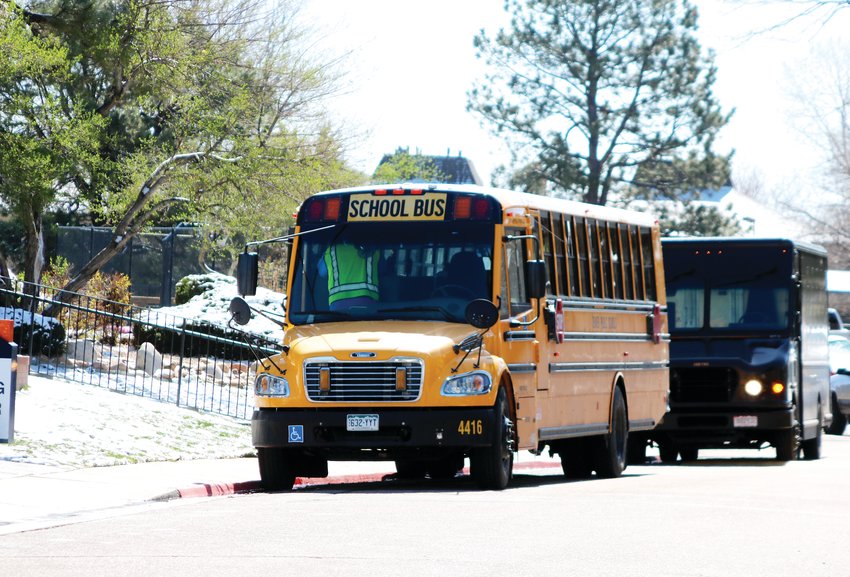 A Denver Public Schools bus parks outside of an apartment complex in Denver’s Hilltop neighborhood to get ready to provide breakfast and lunch to students as part of the district’s food distribution program.