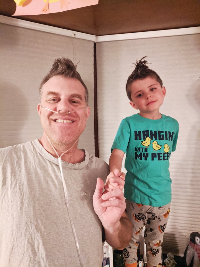 Brian Seamon and his son, Avery, after Brian's return from the ICU, where he was treated for COVID-19.