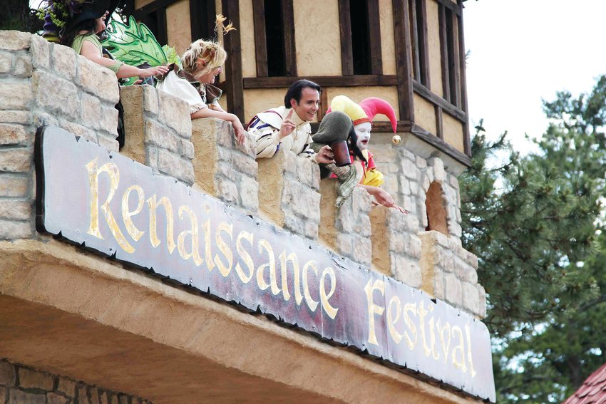 Entertainers greet people from above as they pass through the gates of the Colorado Renaissance Festival castle in July 2019.