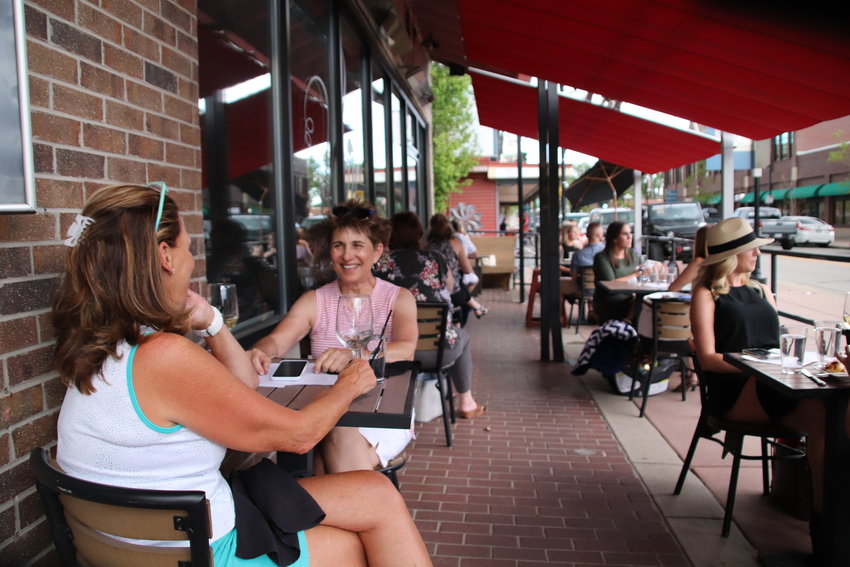 People dine at Vines Wine Bar in Parker May 29. Restaurants are once again allowed to serve customers on-site with social distancing guidelines in place. The Town of Parker passed an emergency ordinance allowing restaurants to expand outdoor seating areas to increase capacity.