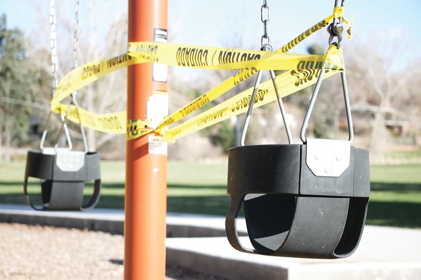 Caution tape wraps swings at Sterne Park in Littleton.
