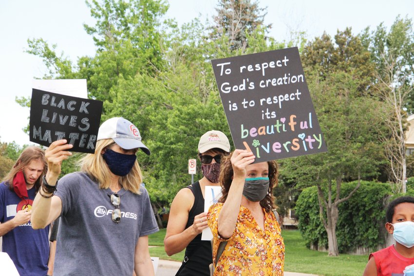 A sign, right, says, "To respect God's creation is to respect its beautiful diversity."