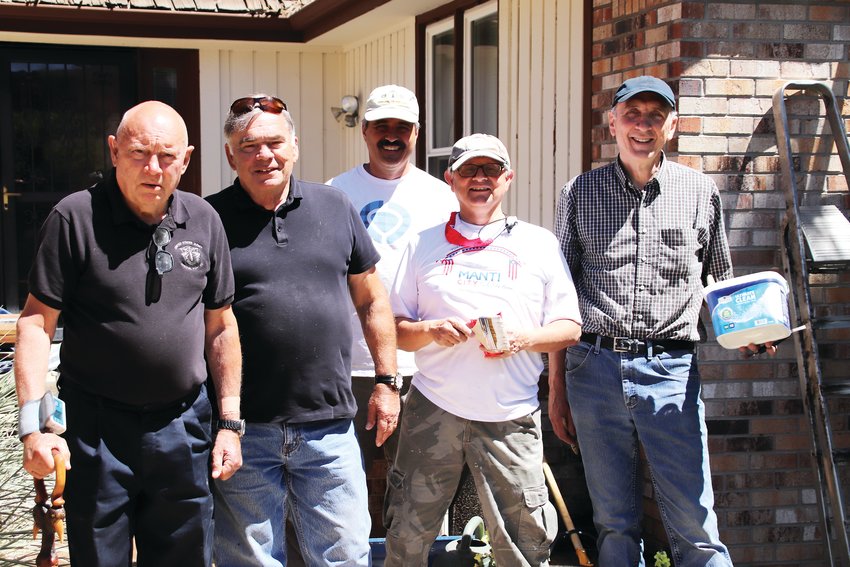 From left, Wes Kouns, Mike Pedersen, Steve Zoolakis, Hamid Ansari, Randy Jones. A group of Lone Tree neighbors and members of the Mormon church have started repairing the outside of Kouns’ home.