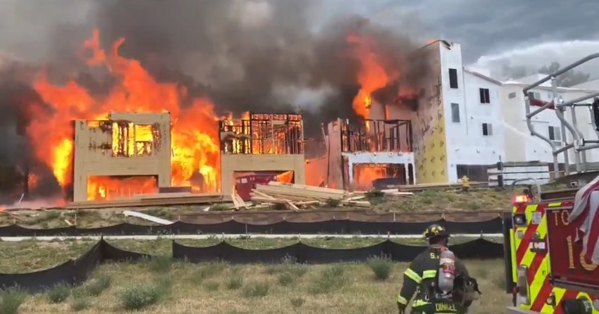 South Metro Fire Rescue crews battle a fire involving a series of woodframe buildings in Highlands Ranch on July 6, 2020.