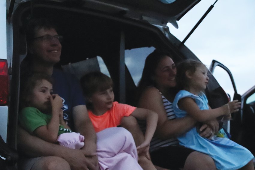 From left, Eric Graham; Sylvia, 4; Elliott, 7; Dahlia, 4; and Rita Graham watch “The Lion King” at a July 16 drive-in movie event at the Cherry Creek Innovation Campus. The central Centennial-area event is one of the first-ever drive-in movies put on by the city. Centennial aimed to bring people together while adhering to public health restrictions.