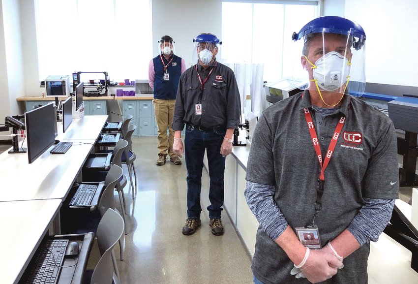 In an April 2020 file photo, personnel at the Cherry Creek Innovation Campus in Centennial personnel are seen wearing face masks and shields.