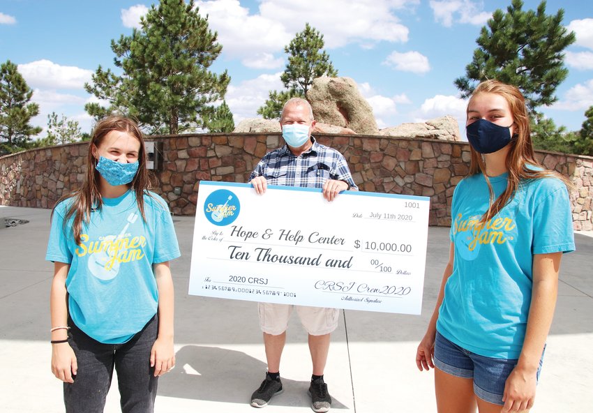 Katie Saunders and Katelyn Clarke presented Help and Hope Center Executive Director Dan Marlowe with a check for $10,000 on July 30.