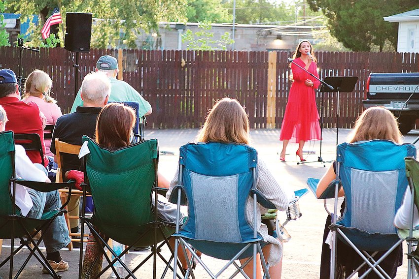 Renowned soloist Siuzanna Iglidan performs for her neighbors in a church parking lot in Englewood on Aug. 1.