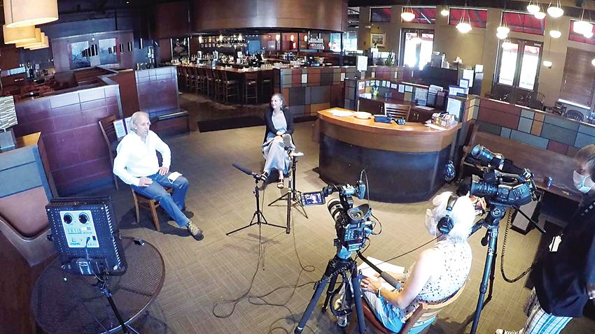 Owners Lee Goodfriend and David Racine are interviewed in the lobby of their restaurant.