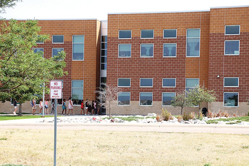 Students file back into school at Clear Sky Elementary School in Castle Rock on Aug. 17, shortly before the first day of the 2020-21 school year came to a close.