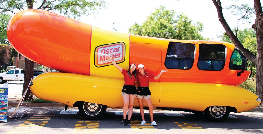Oscar Mayer Hotdoggers Relish Rachel Aul and Ketchup Katie Ferguson stand in front of the iconic Wienermobile during its visit to the Denver Zoo on Aug. 19.