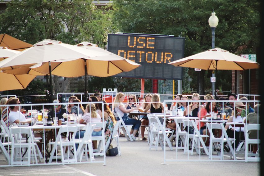 Diners eat and drink at the west end of Littleton's Main Street in July. Offering outdoor dining is one way restaurants have responded to the COVID-19 pandemic.
