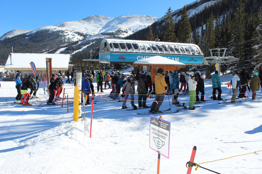 Skiers and snowboarders are instructed to wear a face covering while standing in the lift line during Opening Day on Nov. 11.
