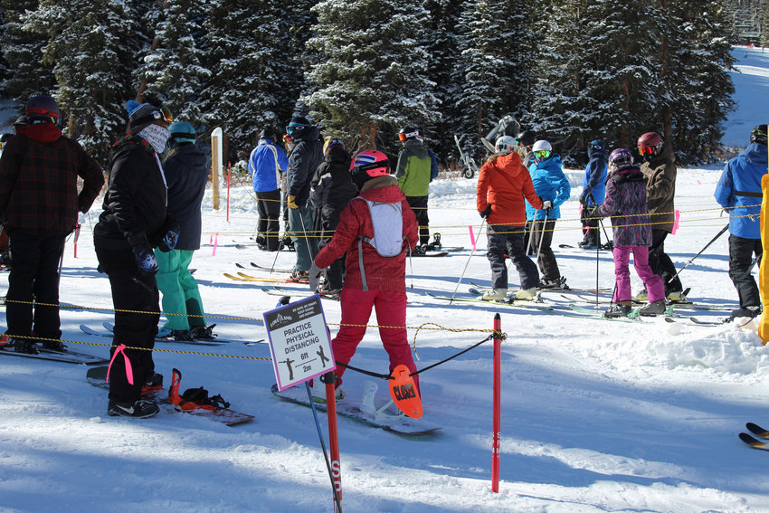 Skiers and snowboarders are cautioned to keep their space while waiting in line for Chet's Dream..