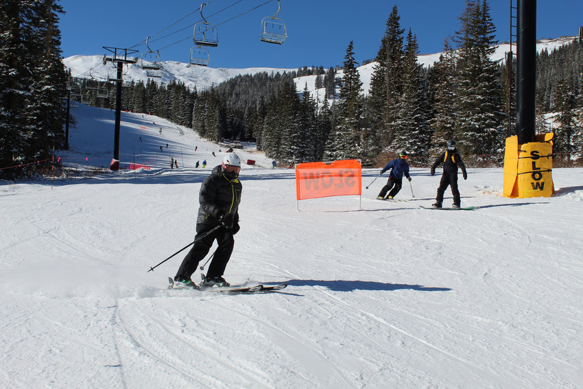 Skiers and snowboarders descend the mountain at Loveland Ski Area on Opening Day, Nov. 11.