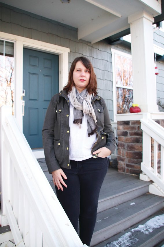 Sarah Tuneberg, whose home address was shared online, poses for a portrait on her front porch.