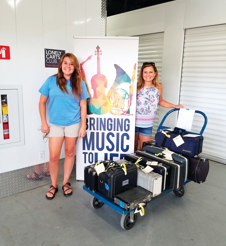 Music teacher Aleaha Harkins and art teacher Pam Jackson, who both teach at Denver Green School Southeast Campus in Denver’s Virginia Vale neighborhood, pick up music instruments for student use during the 2020-2021 school year.
