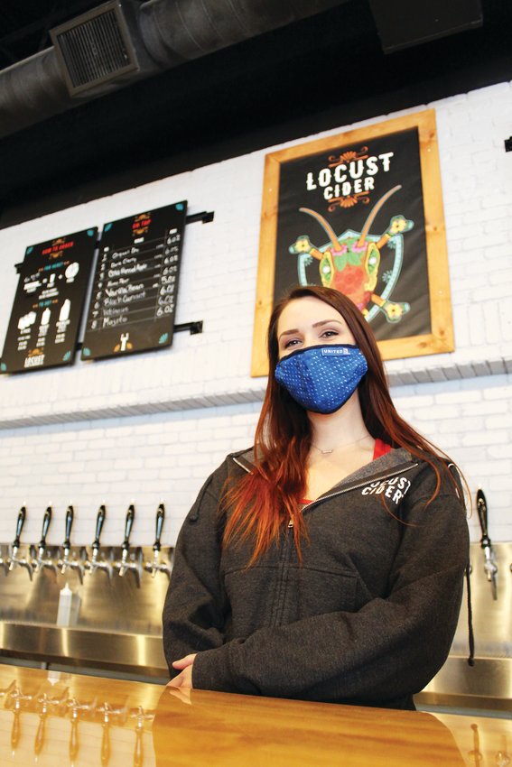 Sarah Mutch, taproom manager, stands behind the bar of Seattle-based Locust Cider's new Belmar location. The taproom features 16 ciders on tap, others in cans, a few wines and a small-plate food menu.