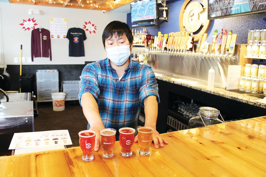 Luke Furey, operations manager at Golden's Colorado + 49 Cidery & Pub, assembles a flight of ciders. The cidery offers flights of five and will be releasing 13 new ciders at its third-anniversary celebration in late June.