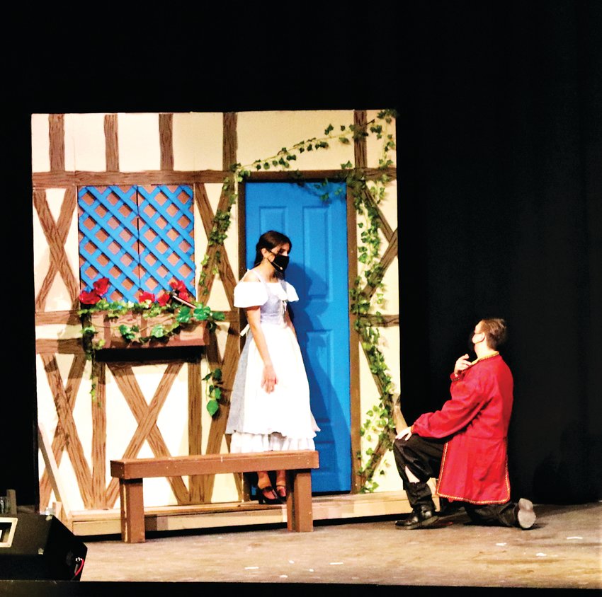 Gaston proposes to Belle (Sophia Davis).