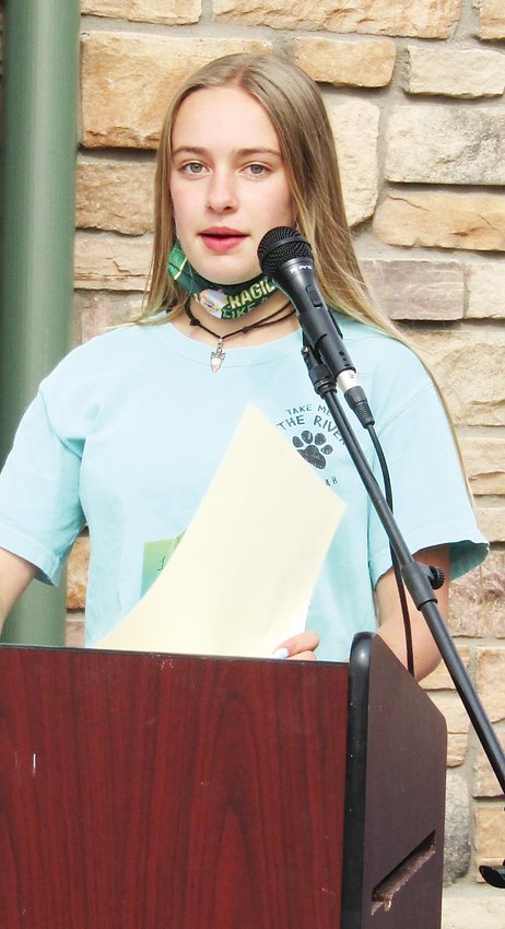 Molly Hochmuth won first place in the writing contest, and she read her poem to the group gathered for the ceremony outside HearthFire Books.