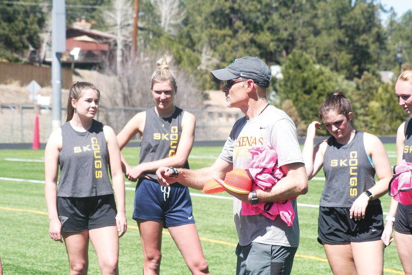 Evergreen girls soccer Head Coach Peter Jeans explains a new drill to his varsity squad during practice last week.