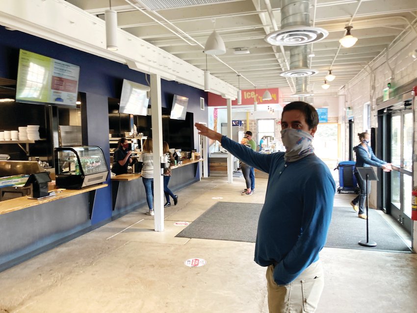 Golden Mill partner Mark Shaker stands inside the downstairs portion of the food hall, where Rolling Smoke BBQ, Republik of Chiken, Tacos Al Chile and Happy Cones are located.