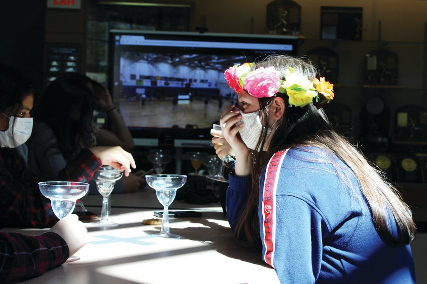 Senior Ariana Peters, right, and her teammates enjoy juice in margarita glasses during the volleyball program's Cinco de Mayo-themed banquet on May 5. Peters was one of the four seniors recognized during the banquet.