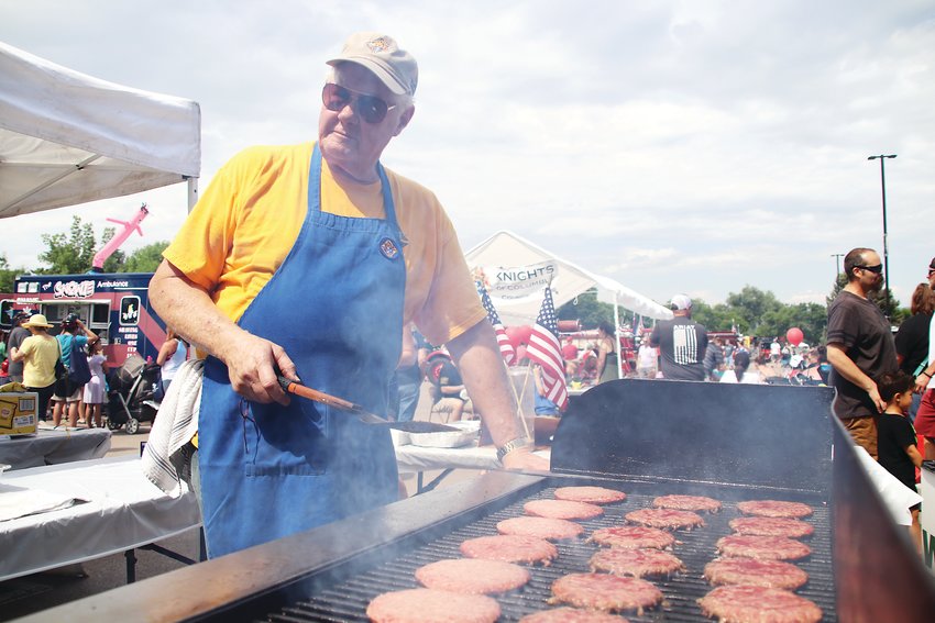Carl Kruse of the Knights of Columbus grills up a mess of burgers.