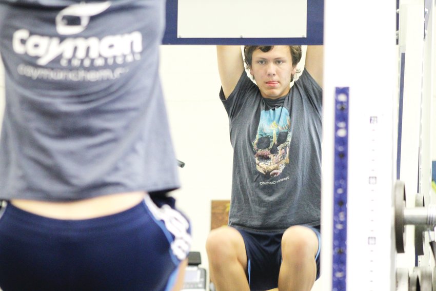 Clear Creek track and field athlete Camden Fahnline does leg lifts in the weight room during track and field practice June 17. The team competed in its last meet of the regular season the next day.