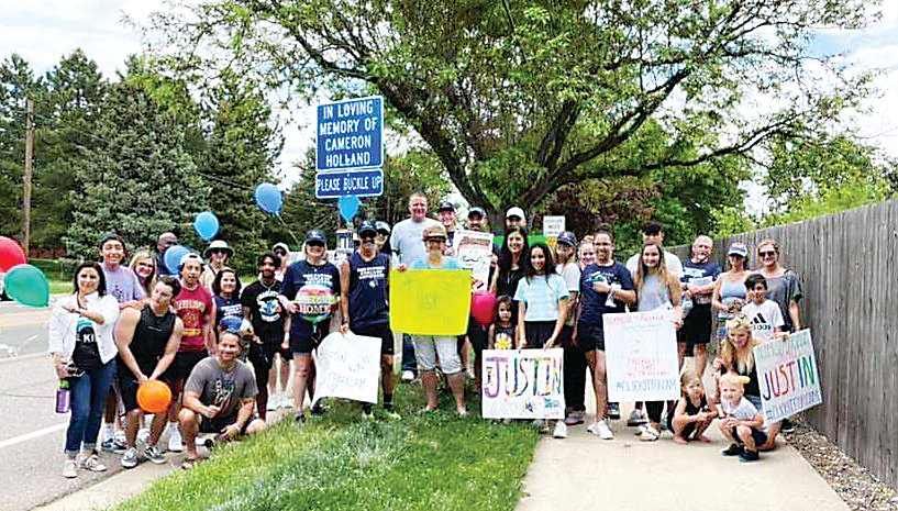 Supporters gather near Cameron Holland’s sign near 72nd and Indiana on June 7, the 18-month anniversary of Cameron’s passing.