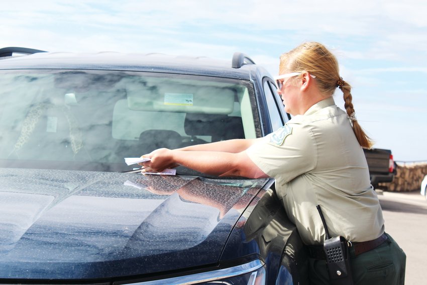 U.S. Forest Service Ranger Hillary Schuler conducts parking enforcement in the Mount Evans summit parking lot on July 22.