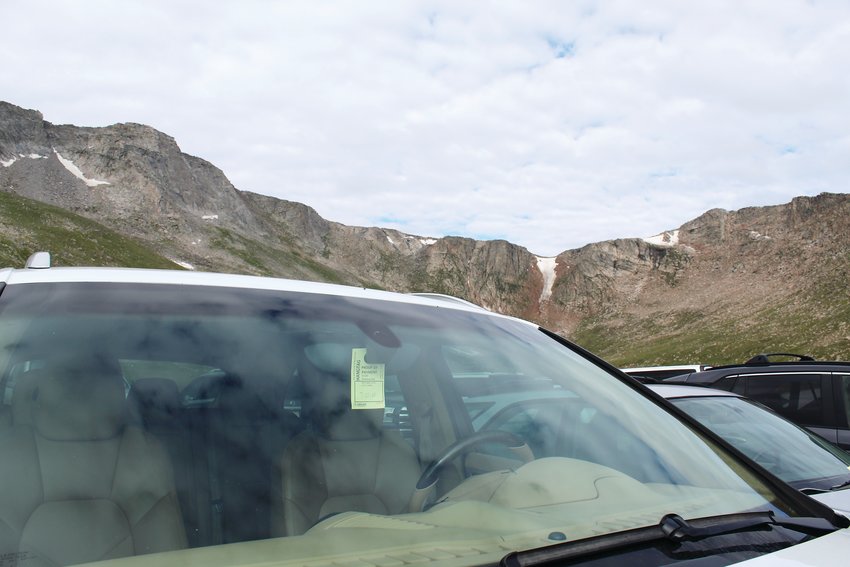 A vehicle has a proof-of-purchase tag visible while parked at Summit Lake, which is along the Mount Evans Scenic Byway, on July 22.
