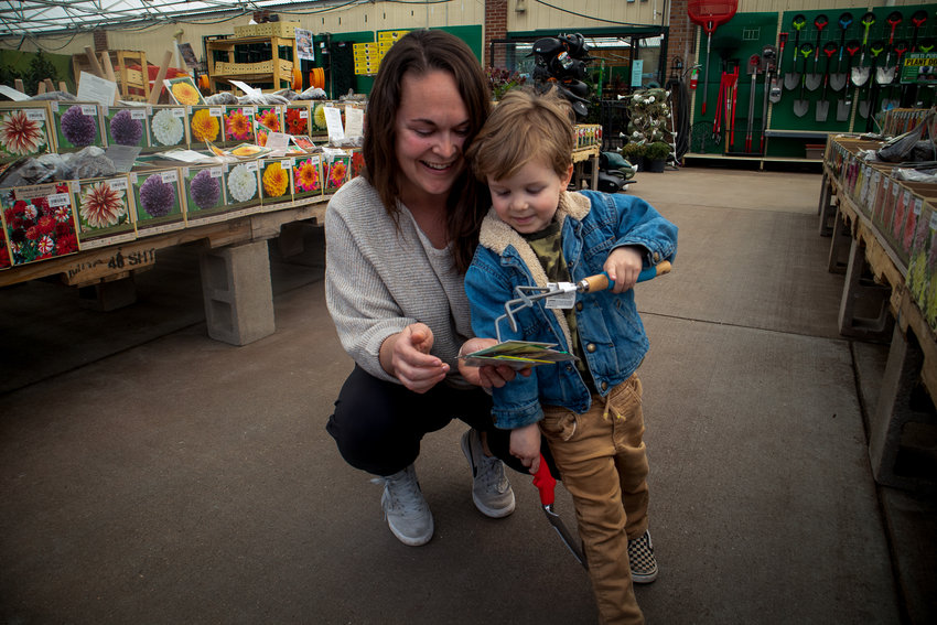 Robyn Harberger and her 3-year-old son, Jonas, look at seeds at O'Toole's Garden Center in Littleton. Harberger said the store has been a staple of family traditions and often finds it as a place to relax.