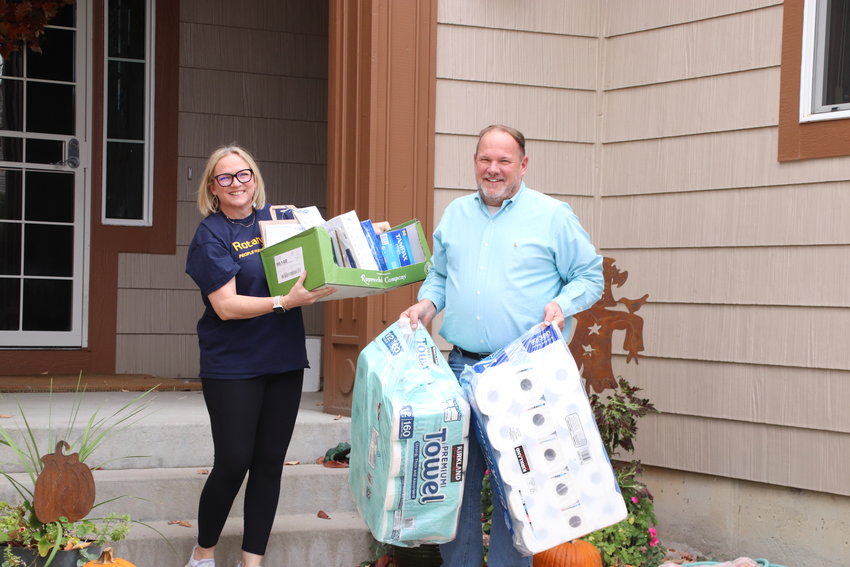 Denver South Metro Rotary Club members Mindy and Mike Waite gather donated items off porches in the Highlands Ranch golf club neighborhood on Oct. 25. The club focused on collecting hygiene products to meet the demand seen by Integrated Family Community Services.