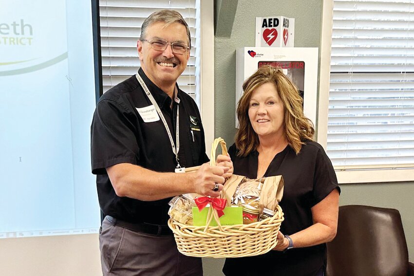 Food Services Director Teri Maher celebrates 20 years with the Elizabeth School District. At left is Superintendent Dan Snowberger.