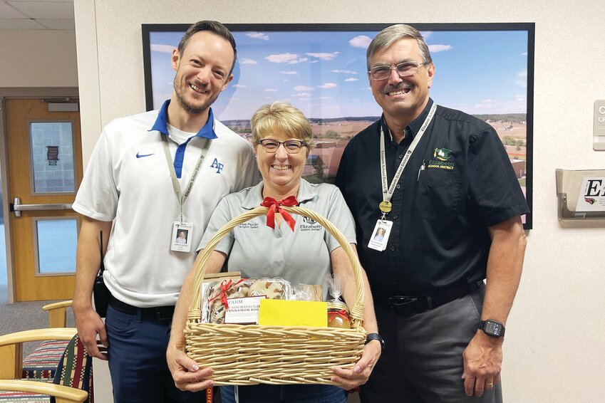 Mary Peavler, security clerk at Elizabeth High School, celebrates 25 years with the district. With her are Elizabeth High School Assistant Principal / Athletic Director John Everhart, left, and Superintendent Dan Snowberger.